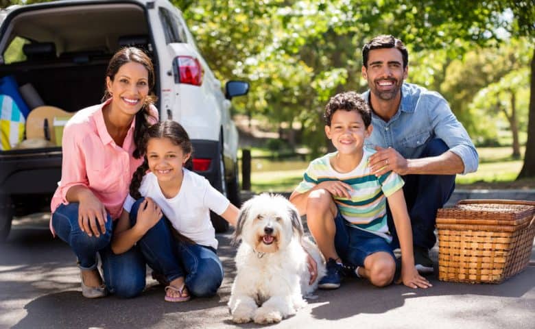 Complete family on a picnic with their dog