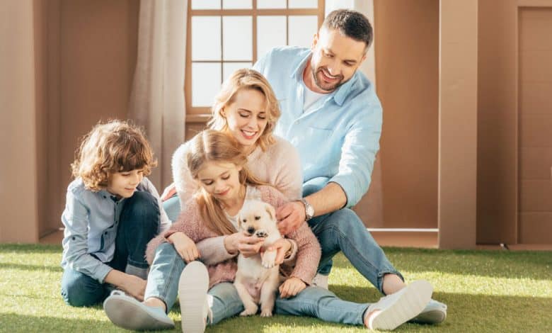 Happy family with their new yellow Labrador puppy