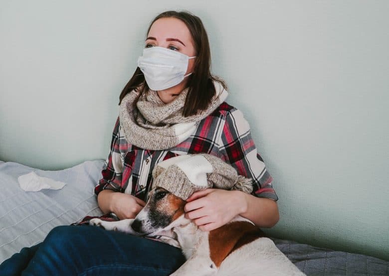 a woman with an allergic reaction to a dog wearing a mask 