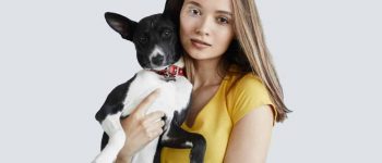 Young woman holding a dog