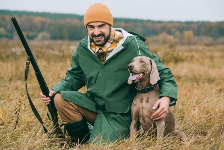 A hunter with a hunting dog ready for action