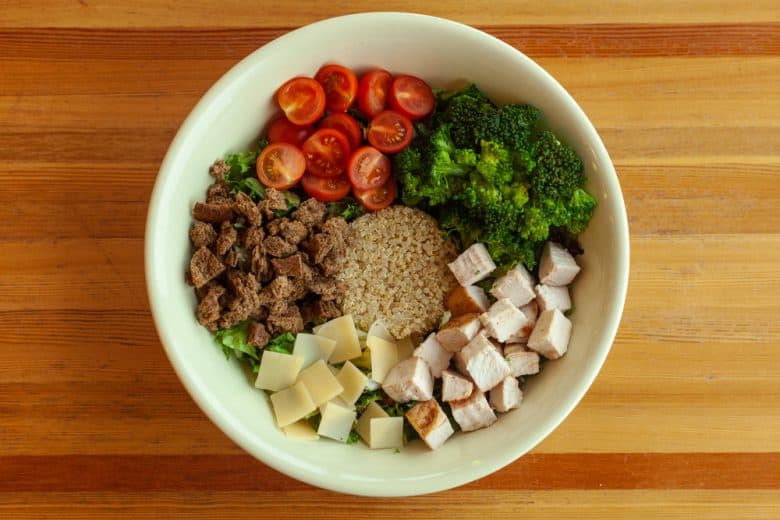 a bowl with healthy serving of grains, veggies, and meats