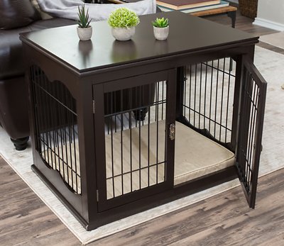 A brown, furniture-style wooden dog crate that also serves as an end table