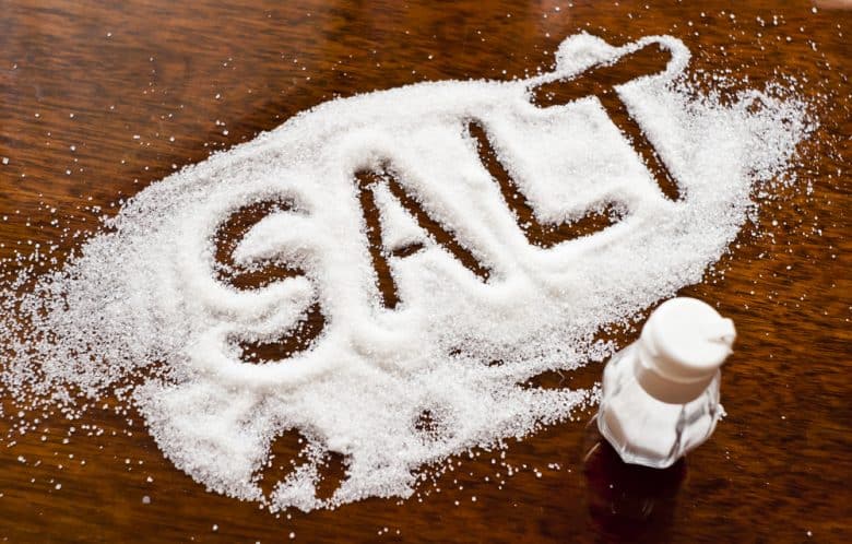 "Salt" written in salt on table