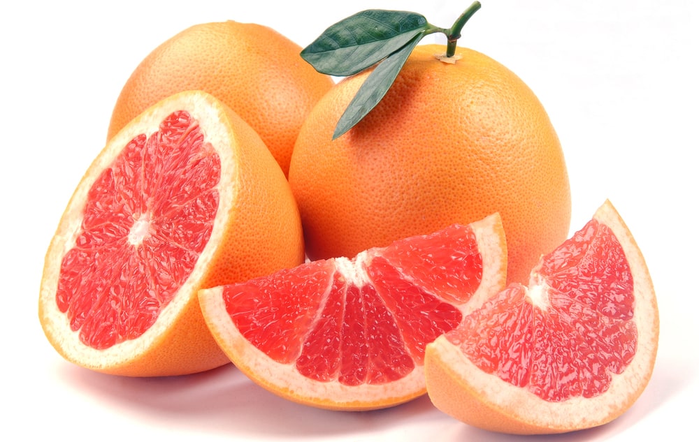A whole and sliced grapefruit