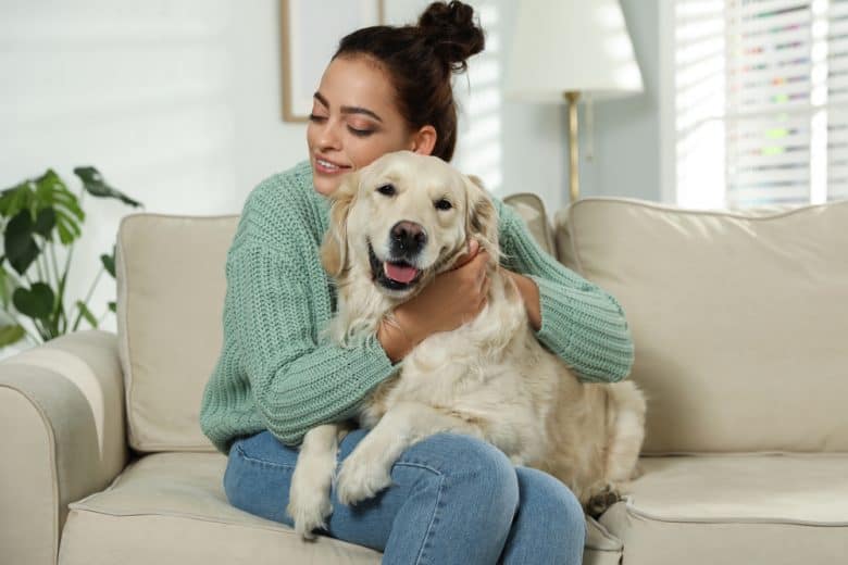 A young woman and her Golden Retriever dog